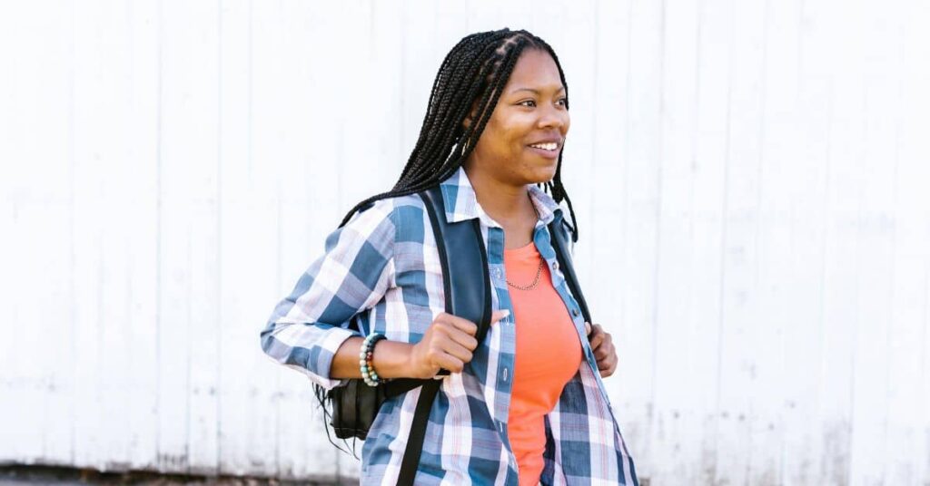 A young adult walking outdoors with confidence, representing financial freedom achieved through the Top Budgeting Tools for 2025.