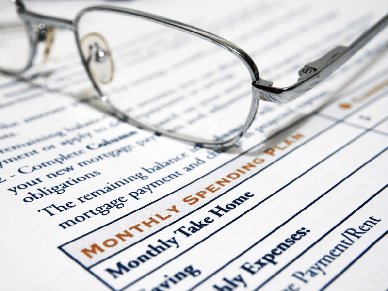 budget sheet with glasses illustrating Gen Z financial advice to track small purchases