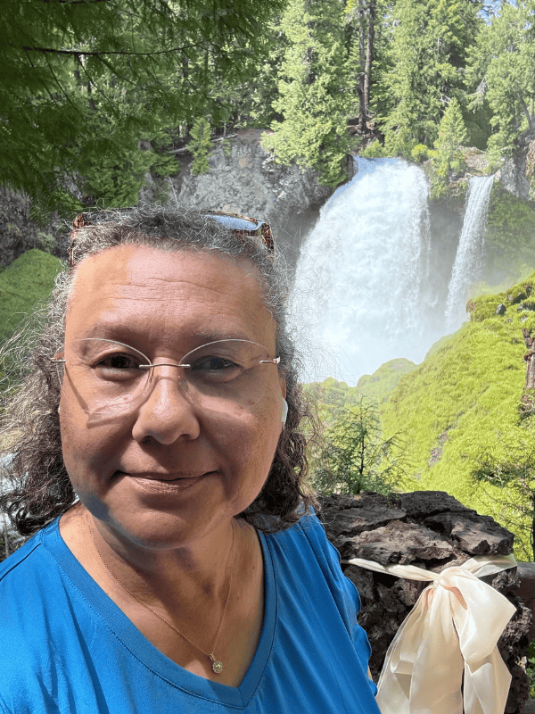 Jacqueline standing near Sahalie Falls reflecting on Gen Z financial advice